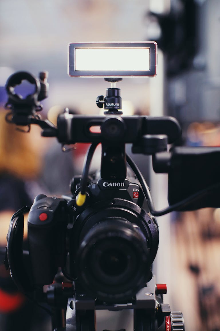 Close-up of a professional video camera with lighting equipment, perfect for filmmaking or video production projects.